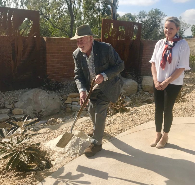 Max Bourke planting bush with Minister Sussan Ley.