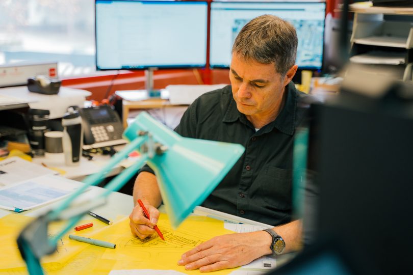 Ross Norwood at work in office at DNA Architects.