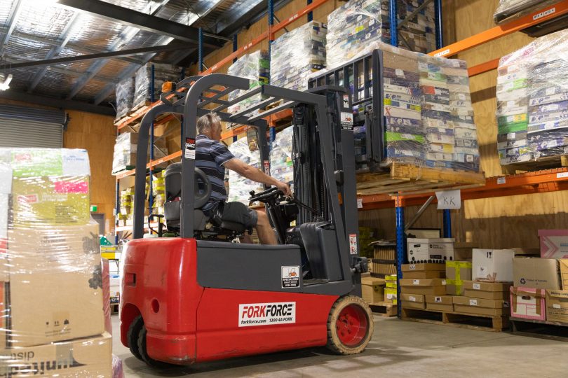 Forklift moving pallet of books at Lifeline Book Warehouse