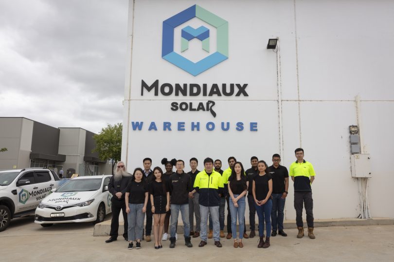 Mondiaux Solar staff standing outside warehouse