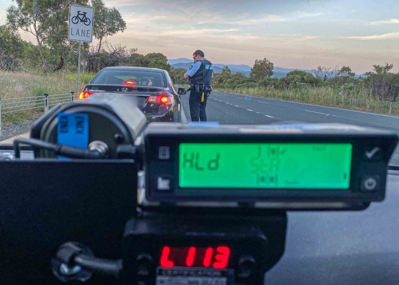 Policeman booking motorist