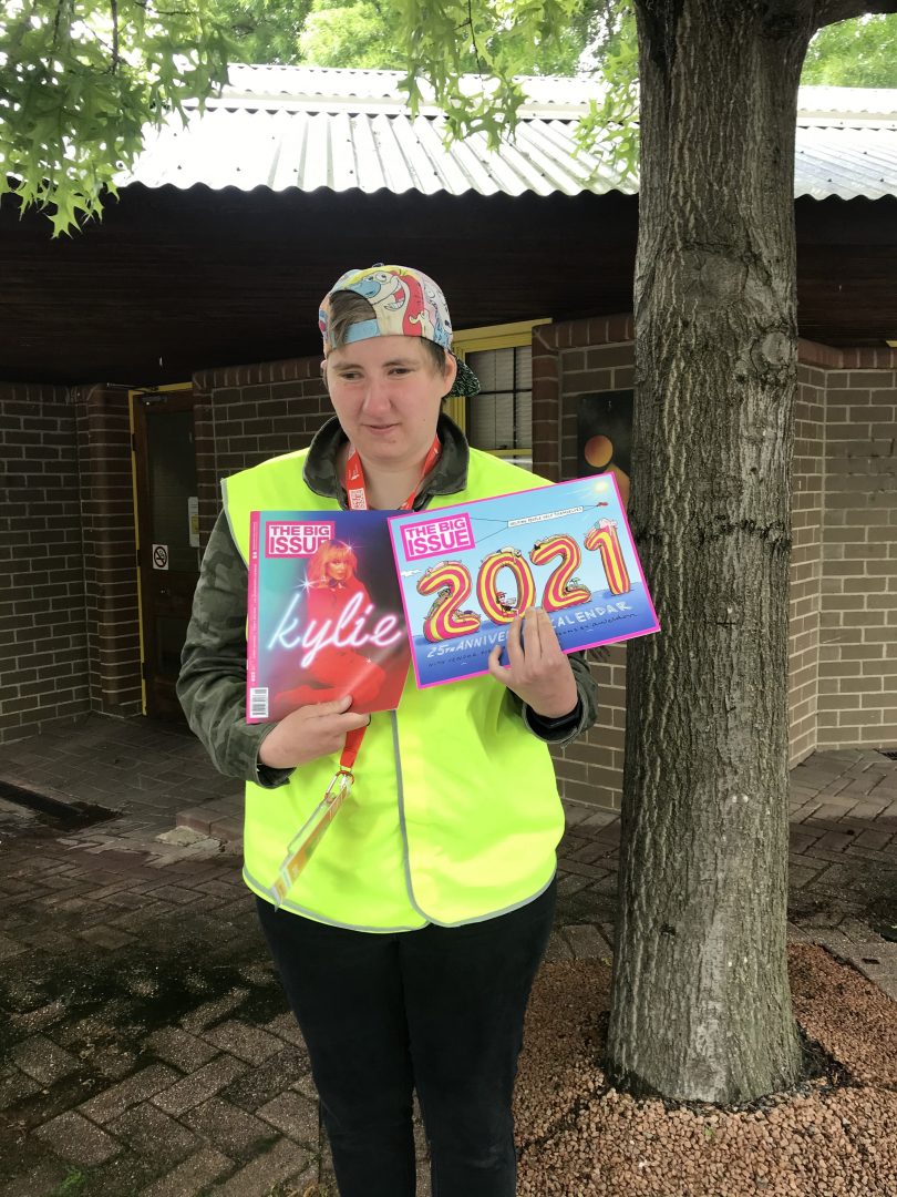 The Big Issue vendor Grace holding magazine and calendar.