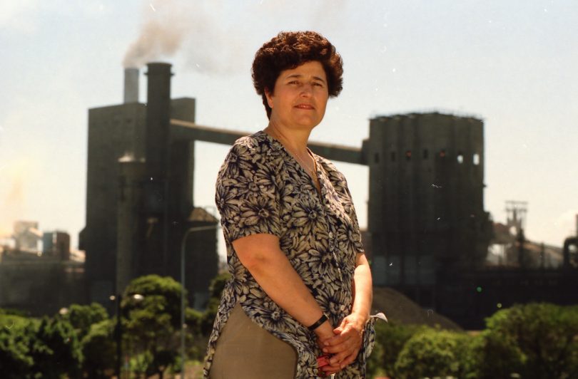 Mara Goluza standing in front of steelworks.