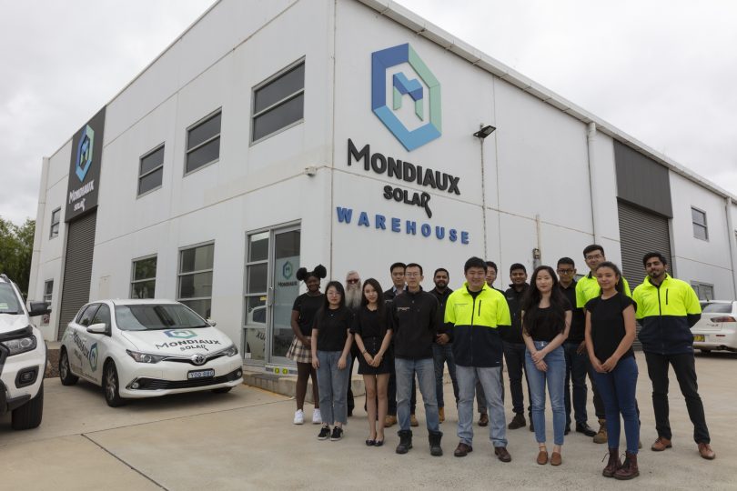 The team from Mondiaux Solar standing outside the company's building.