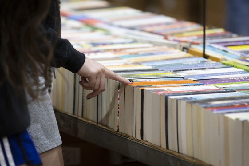 Person looking at books for sale at Lifeline Canberra Book Fair