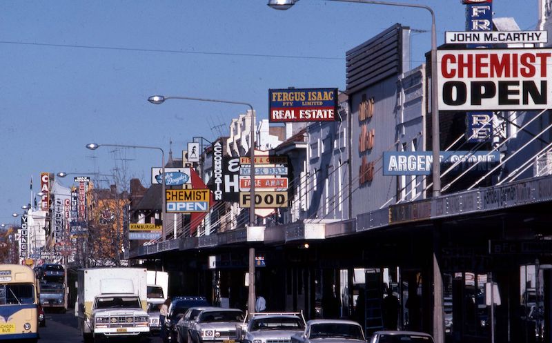 Photo of signs above shop awnings on Auburn Street, Goulburn, in 1982.