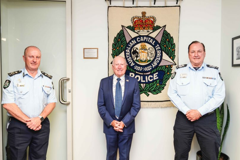 From left: ACT Policing Chief Police Officer Neil Gaughan, ACT Minister for Emergency Services Mick Gentleman, and Sergeant Garry Noble with the ACT Police Badge tapestry.