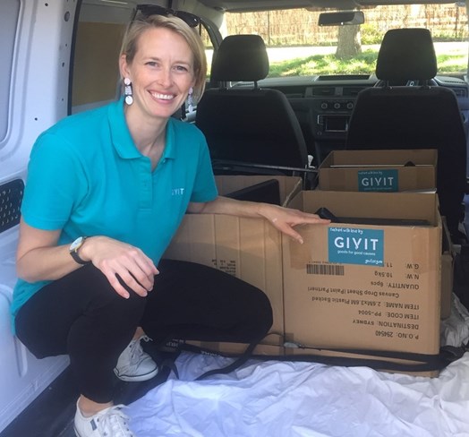 GIVIT ACT engagement coordinator Kristi Clark with a donation of computers refurbished by SOLVit.