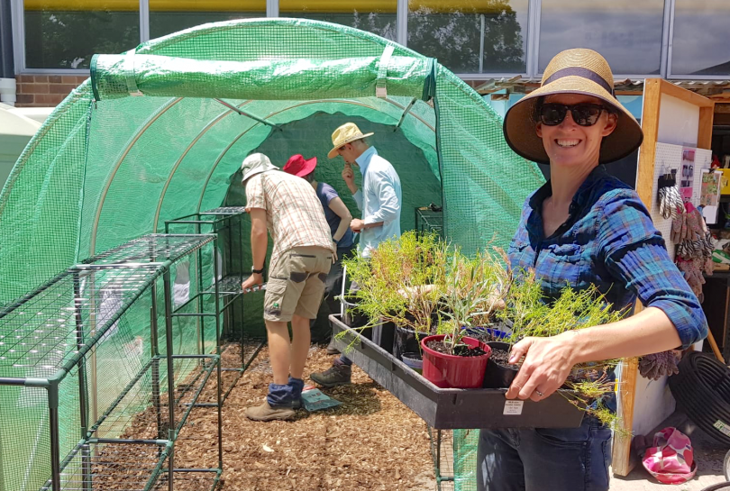 North Ainslie Primary School P&C president Maree Wright holding plant cuttings.