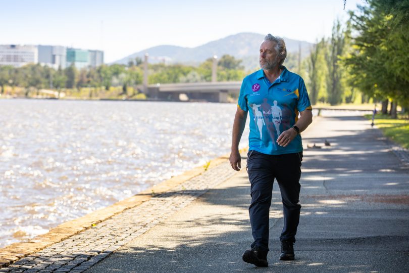 Chris Edwards walking along Lake Burley Griffin foreshore.