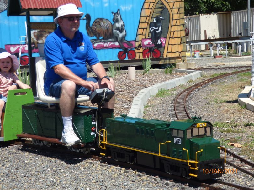 person riding on a miniature train