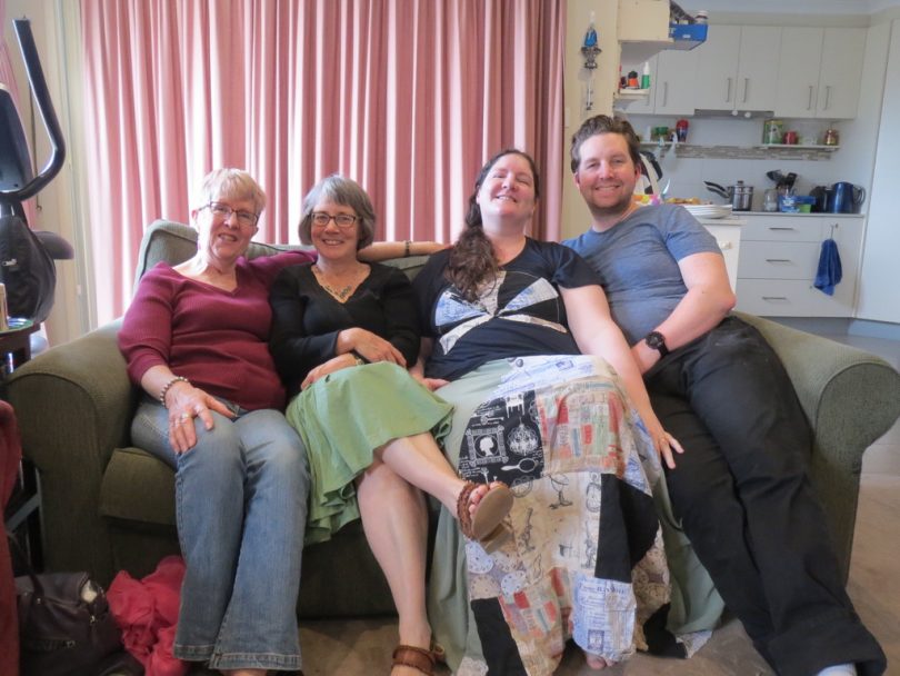 Felicity Banks sitting on couch with members of Castle of Kindness group.