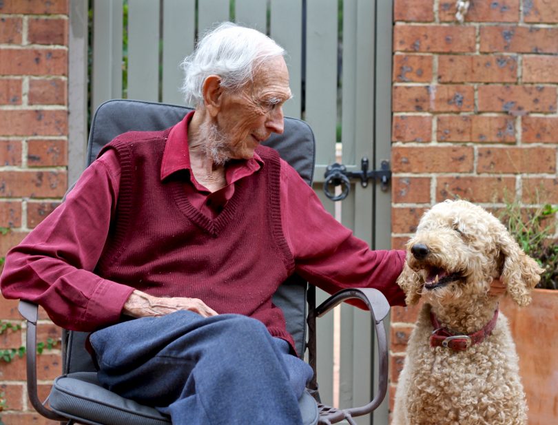 Michael Wilson and his poodle Rosie sitting together.