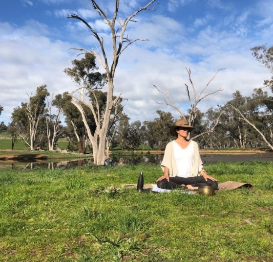 Danette Watson meditating in bush.