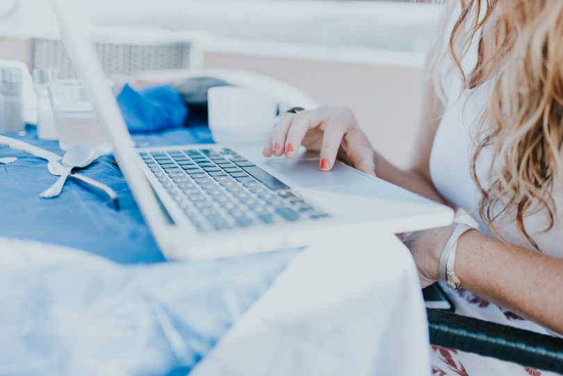 Woman sitting at laptop computer.