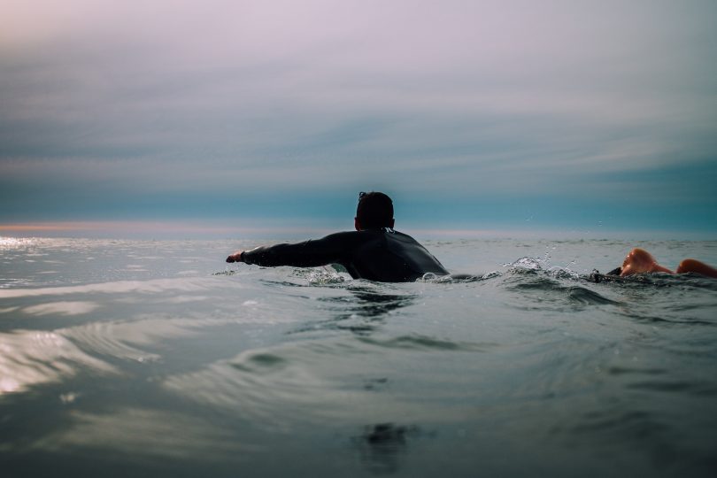 A surfer paddling