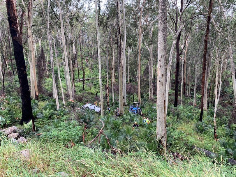 Emergency crews at forest car crash site in Currowan.