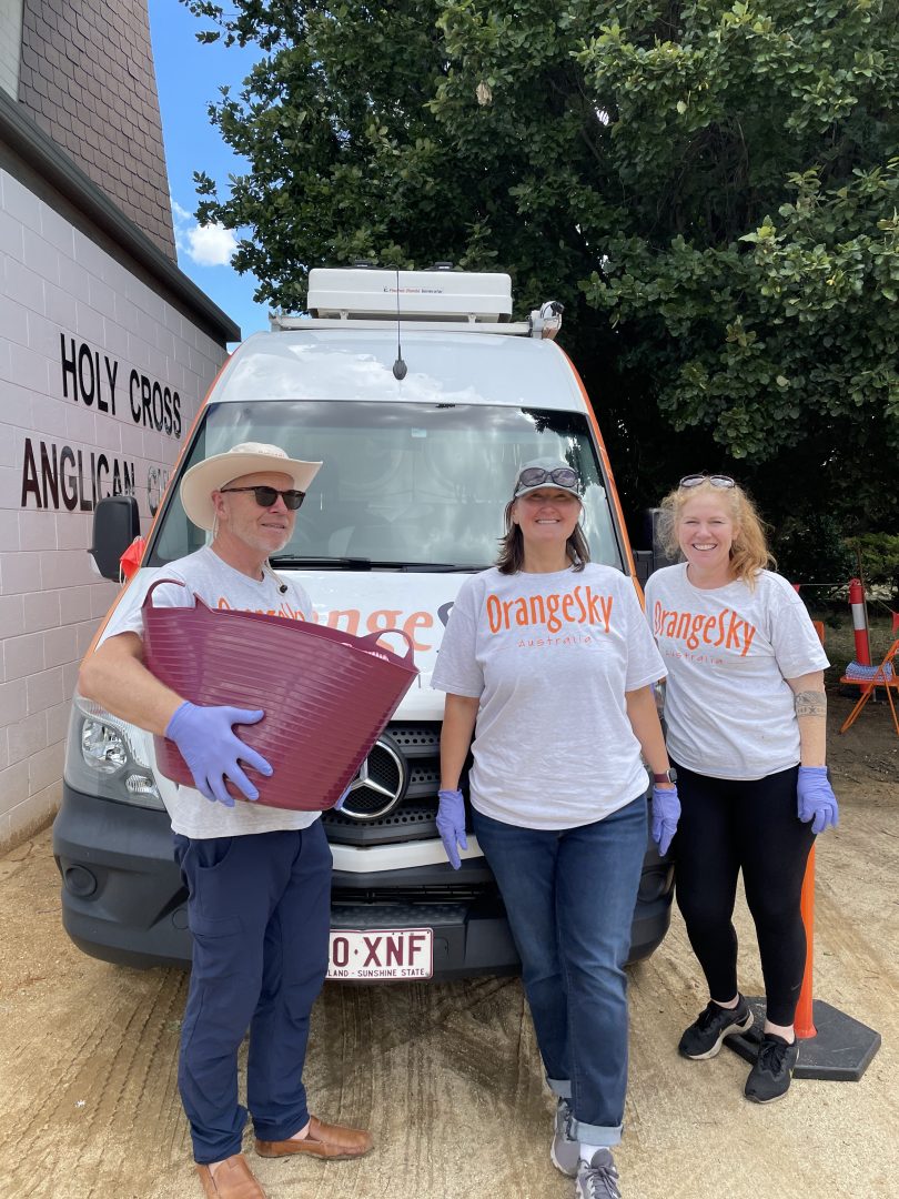 Kevin Jones, Emily Foster and Nicole Vonarx in front of Orange Sky van.