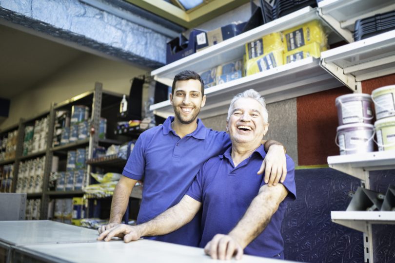 two people standing in a paint store