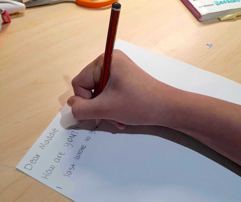 Girl writing a letter to a friend.