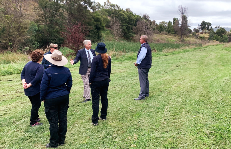 Queanbeyan-Palerang Council's urban landscapes manager Tim Geyer (3rd from right) with mayor Tim Overall (right) and residents on the proposed site for the botanic garden. 