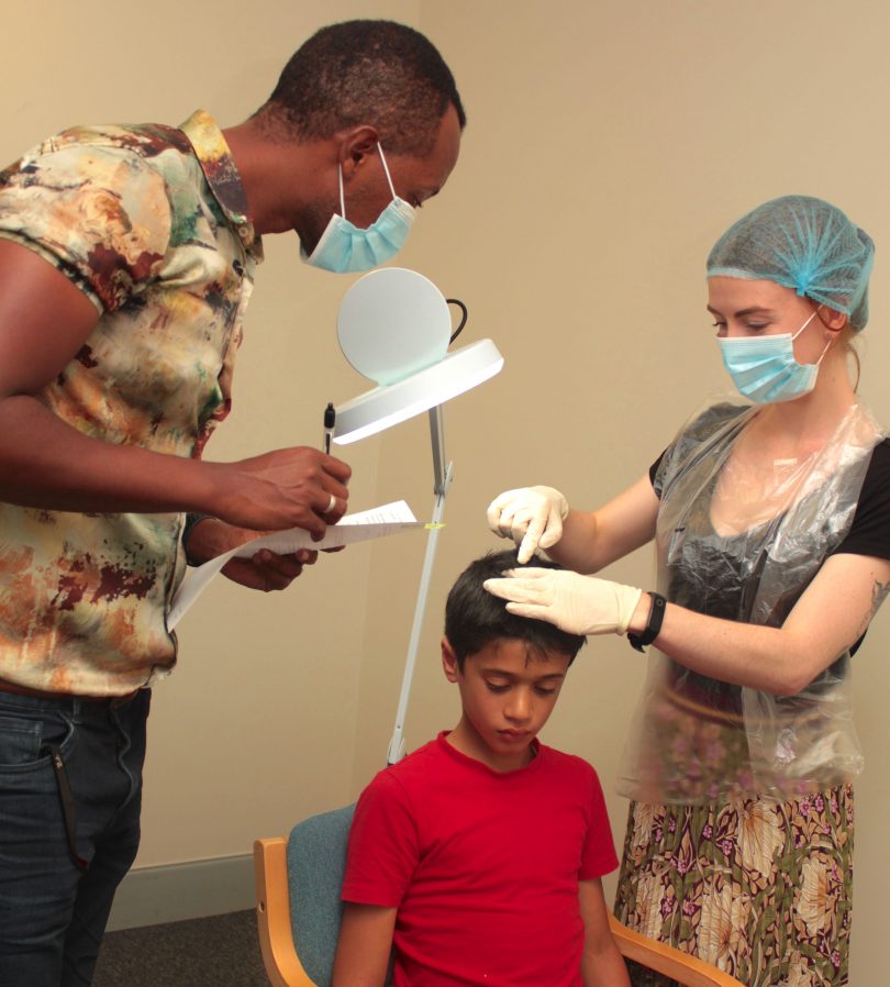 Researcher at University of Canberra Webshet Tesfaye during the head lice trial