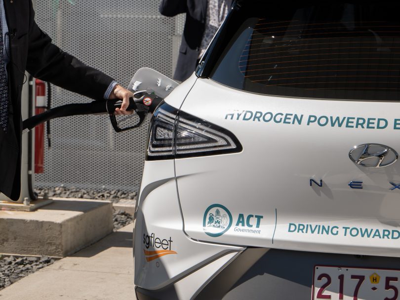 Car being filled at hydrogen refuelling station