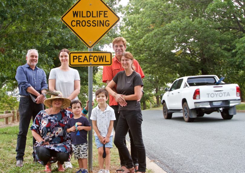 Save the Narrabundah Peafowl group members standing in front of warning road sign for peafowl