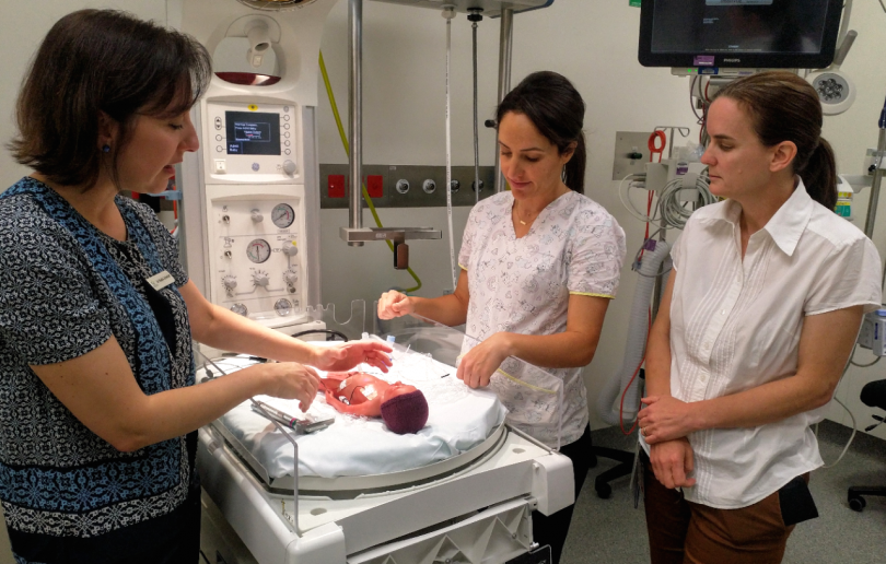 Dr Nadia Schmidt and nurses at Canberra Hospital's Neonatal Intensive Care Unit, with premature baby 'Paul'.