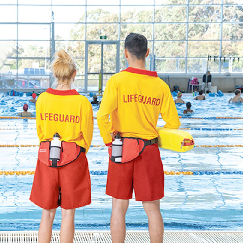 Two swim instructors at a pool.