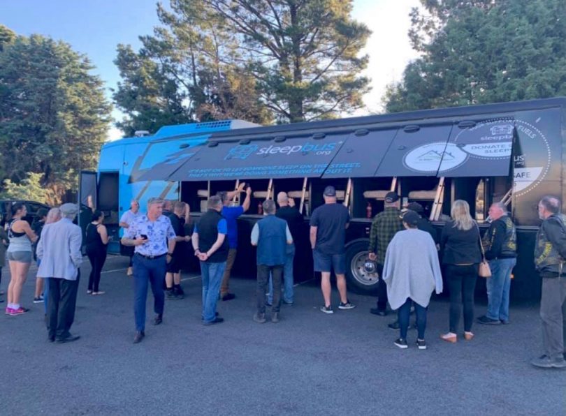 People standing in front of the sleepbus