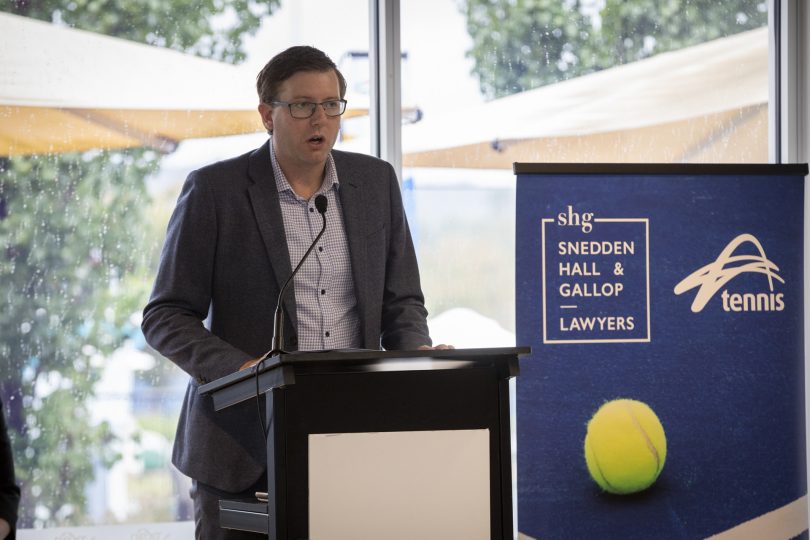 man standing at lectern