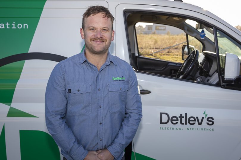 Grae Munro standing in front of a truck smiling