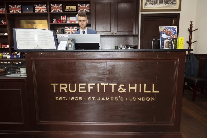 Man behind counter at Truefitt & Hill