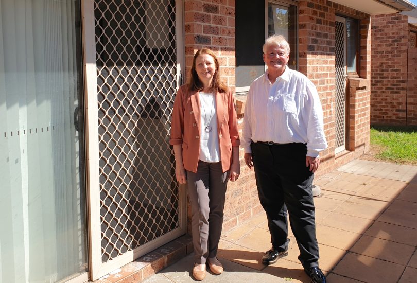 Janette Dale and Deb Strickland standing at rear of house in Queanbeyan