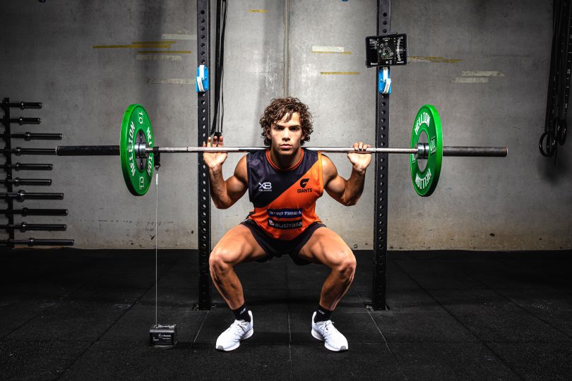 AFL player from GWS Giants doing squat with GymAware system in weight training room