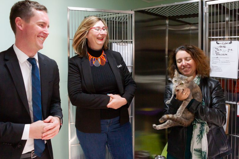 Three people and a cat at the RSPCA in Canberra