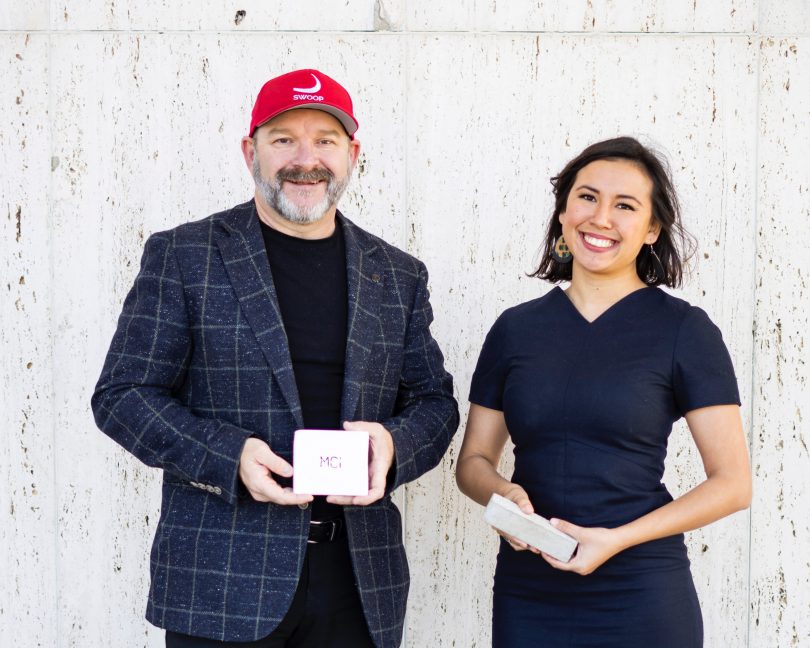 two people hold products