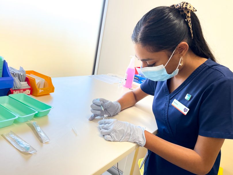 Nurse Marisha Christian preparing COVID-19 vaccine at Calvary Hospital clinic