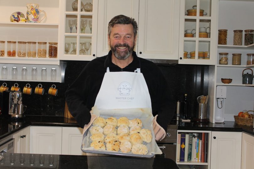 Peter Cursley holding tray of scones