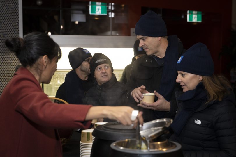 People collecting soup