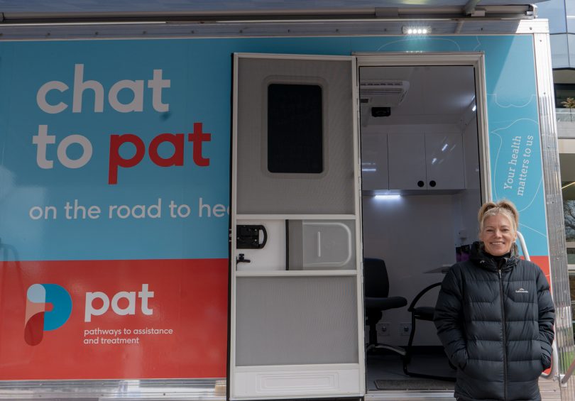 Ali Loom standing infront of the mobile health van