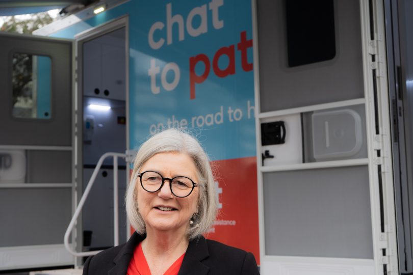 Bronwyn Hendry standing in front of 'Chat to Pat' mobile health clinic