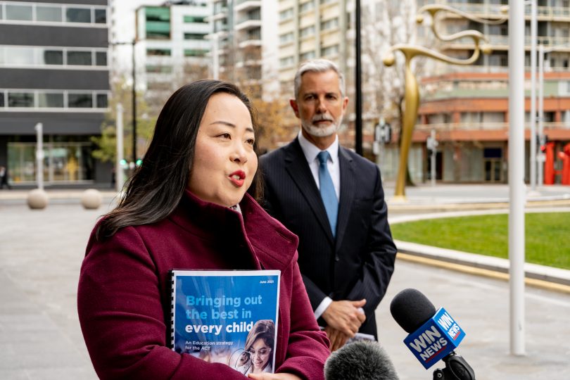 Elizabeth Lee holding the education strategy report