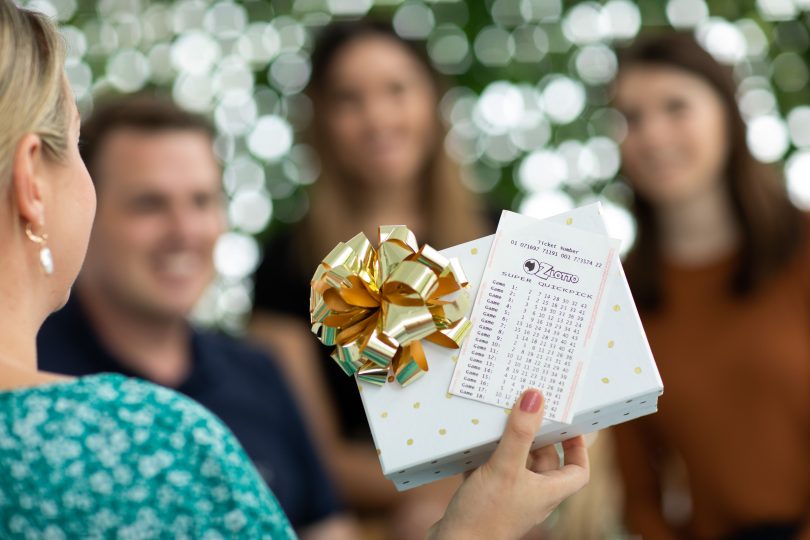 Woman holding Lotto ticket