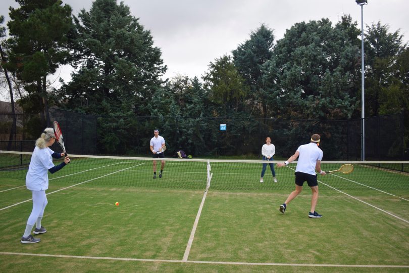 people playing tennis on court