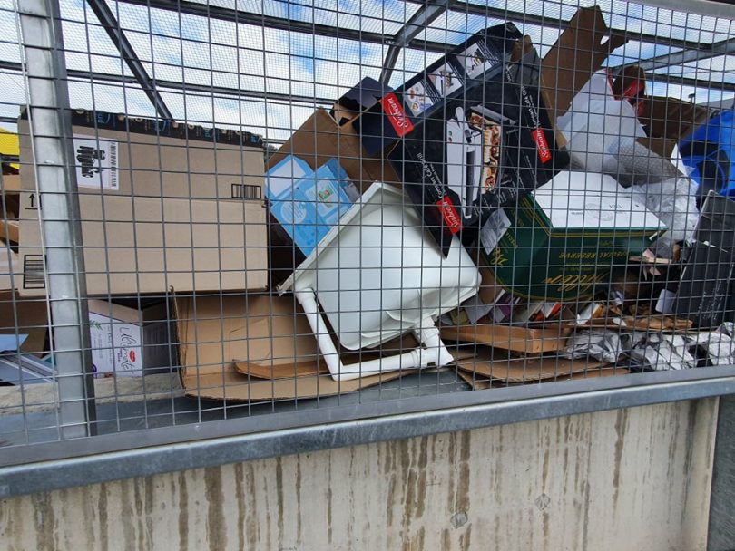 A plastic sink in the cardboard cage