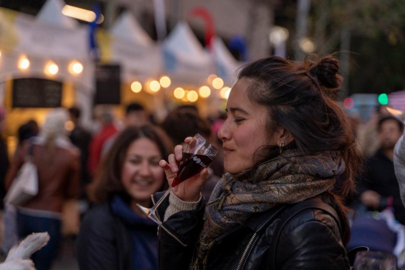 Woman drinking mulled wine at Christmas in July event