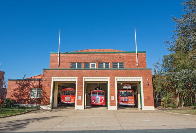 Forrest Fire Station and three red trucks