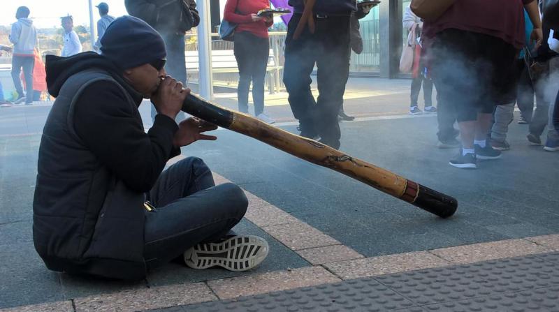 man playing didgeridoo 